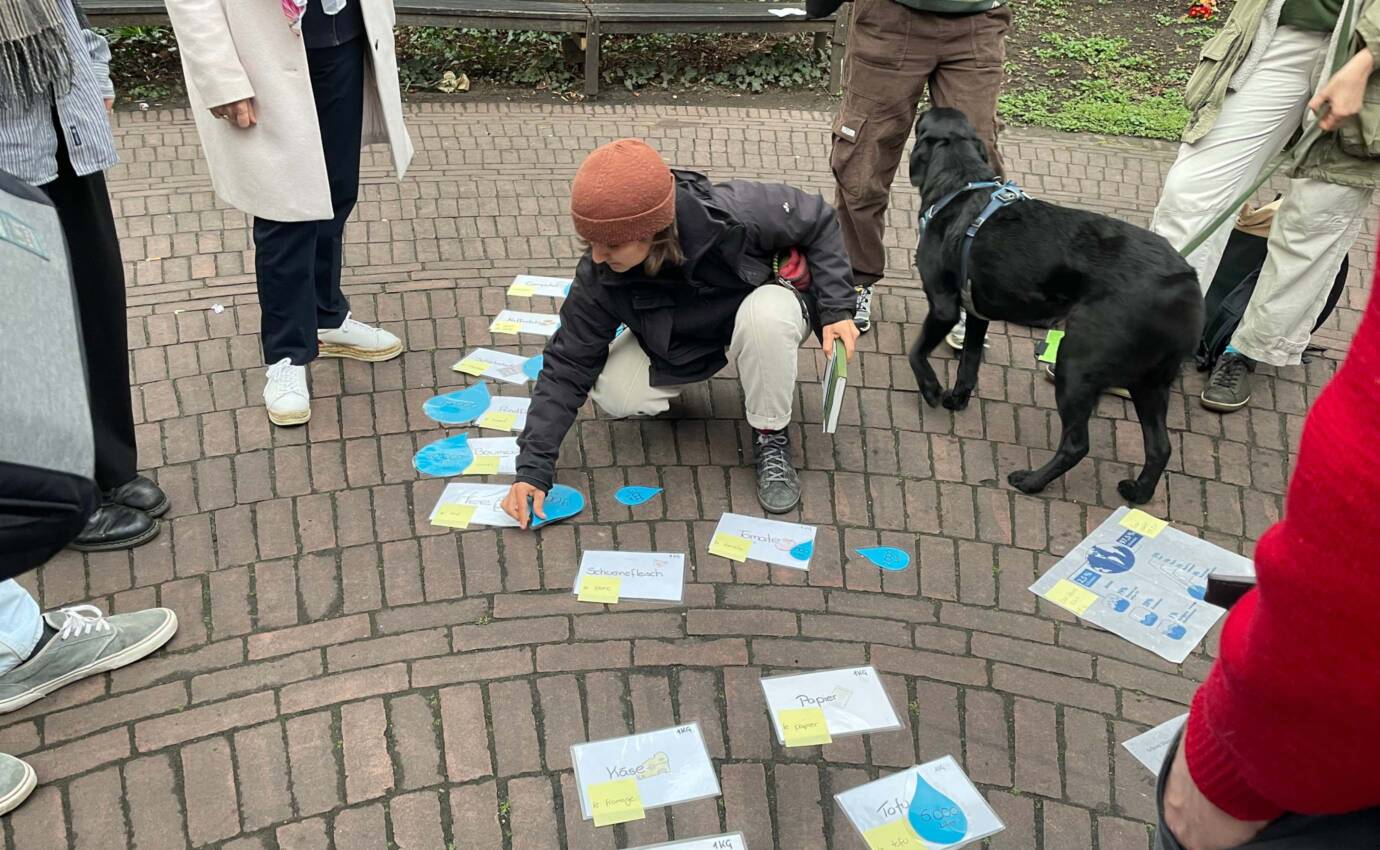 Menschen diskutieren über Schilder auf dem Boden im Freien.