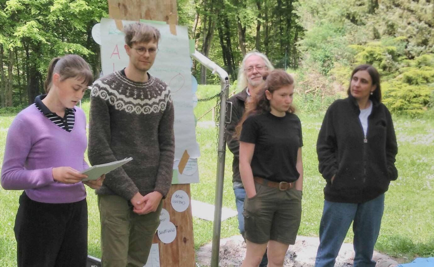Gruppe von Menschen bei Präsentation im Freien.